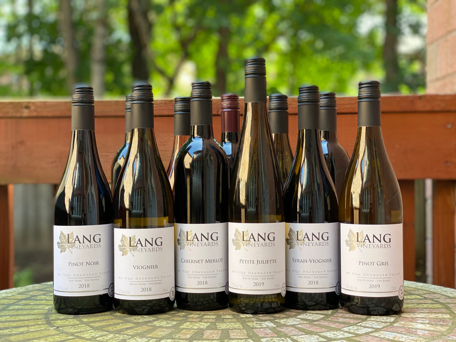 Lang Vineyards wine bottles on a rustic table for promotional purposes