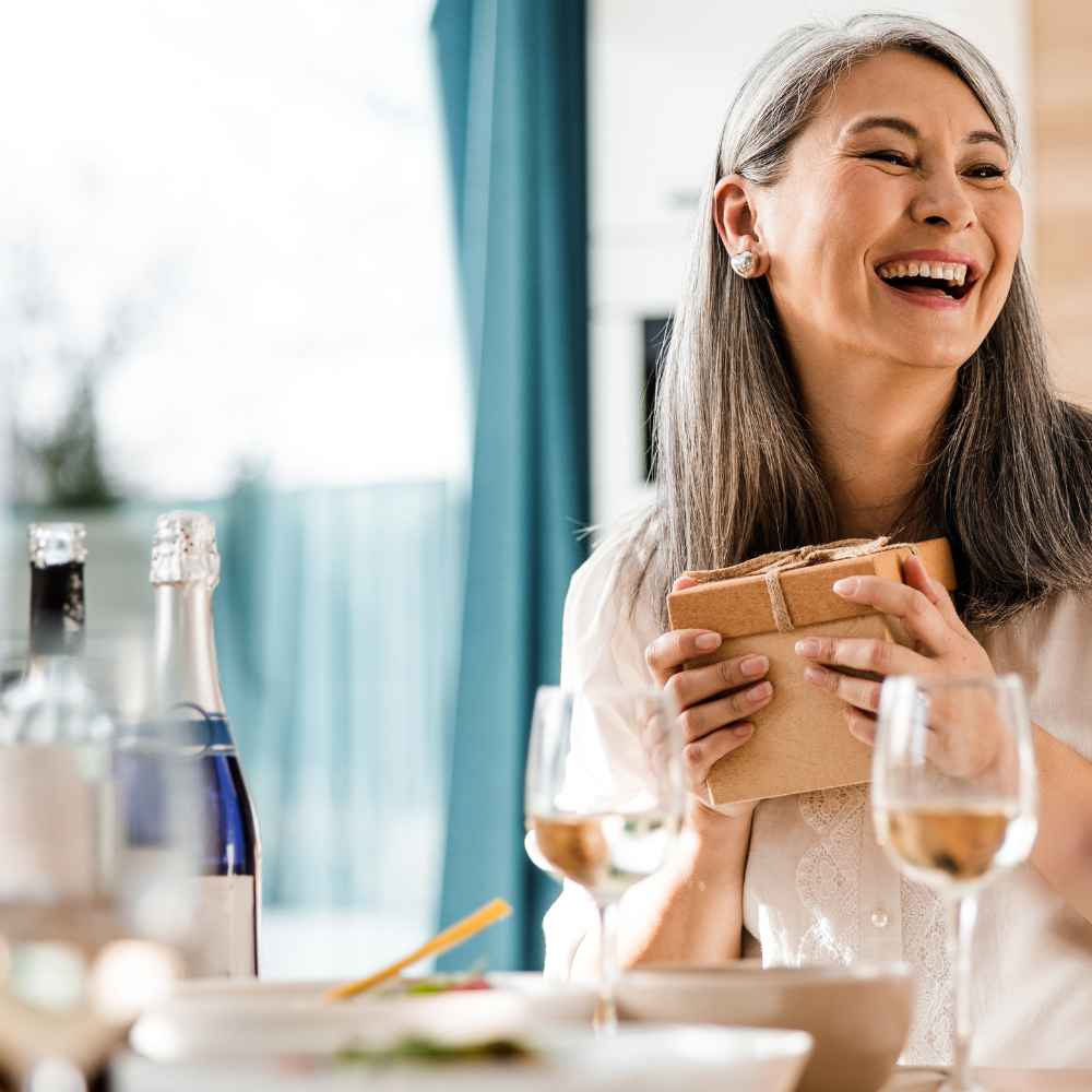 Woman receiving a gift subscription of mixed red and white wine