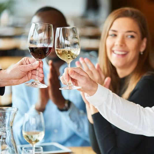 Mixed red and white wine glasses in corporate gift dinner