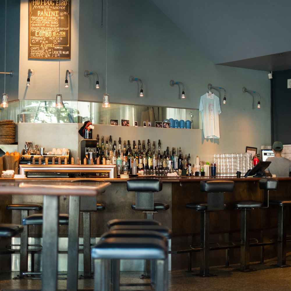 Bar in montreal showing unique style with bottles and high chairs