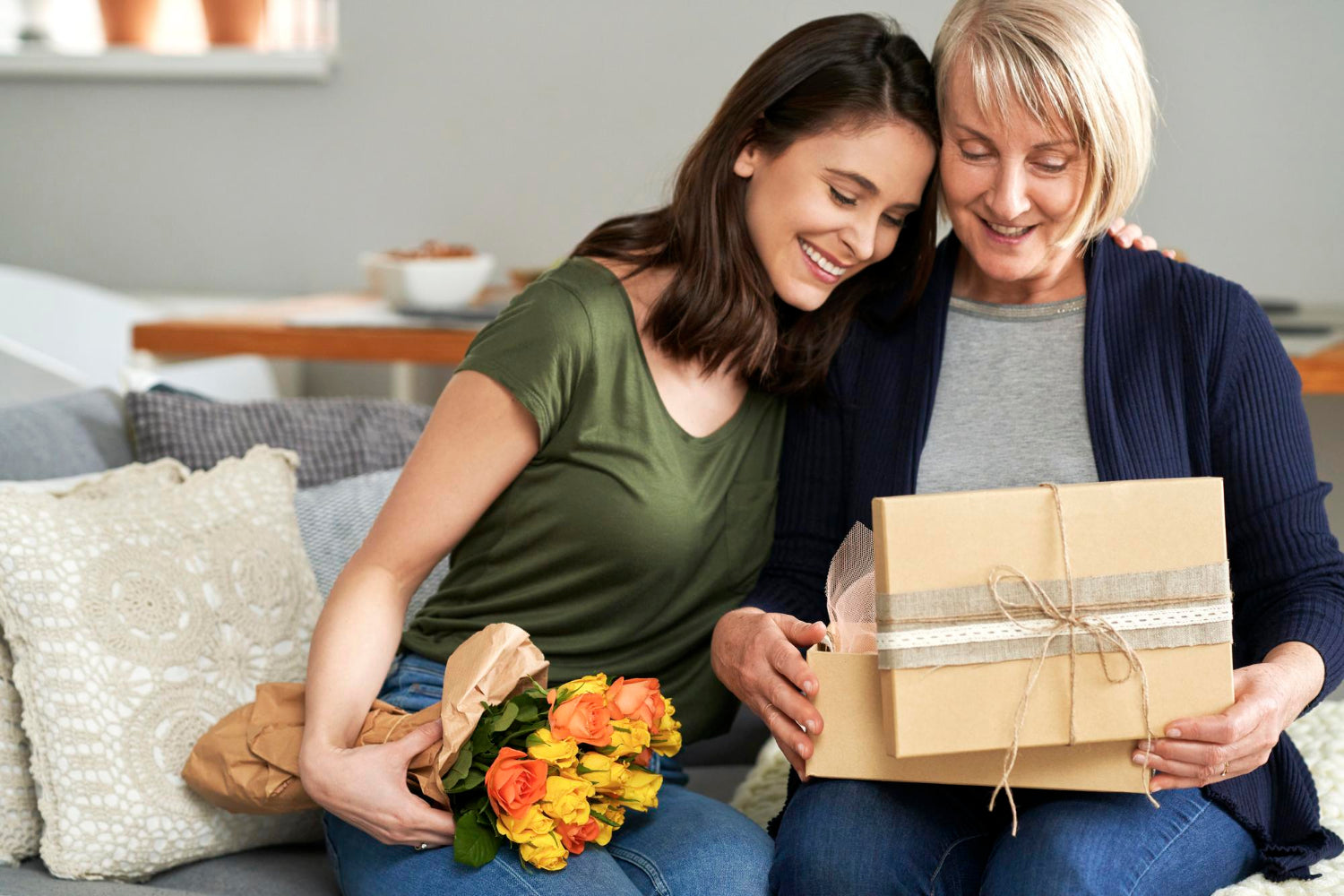 Watching as she opens the cozy gift that many moms adore.