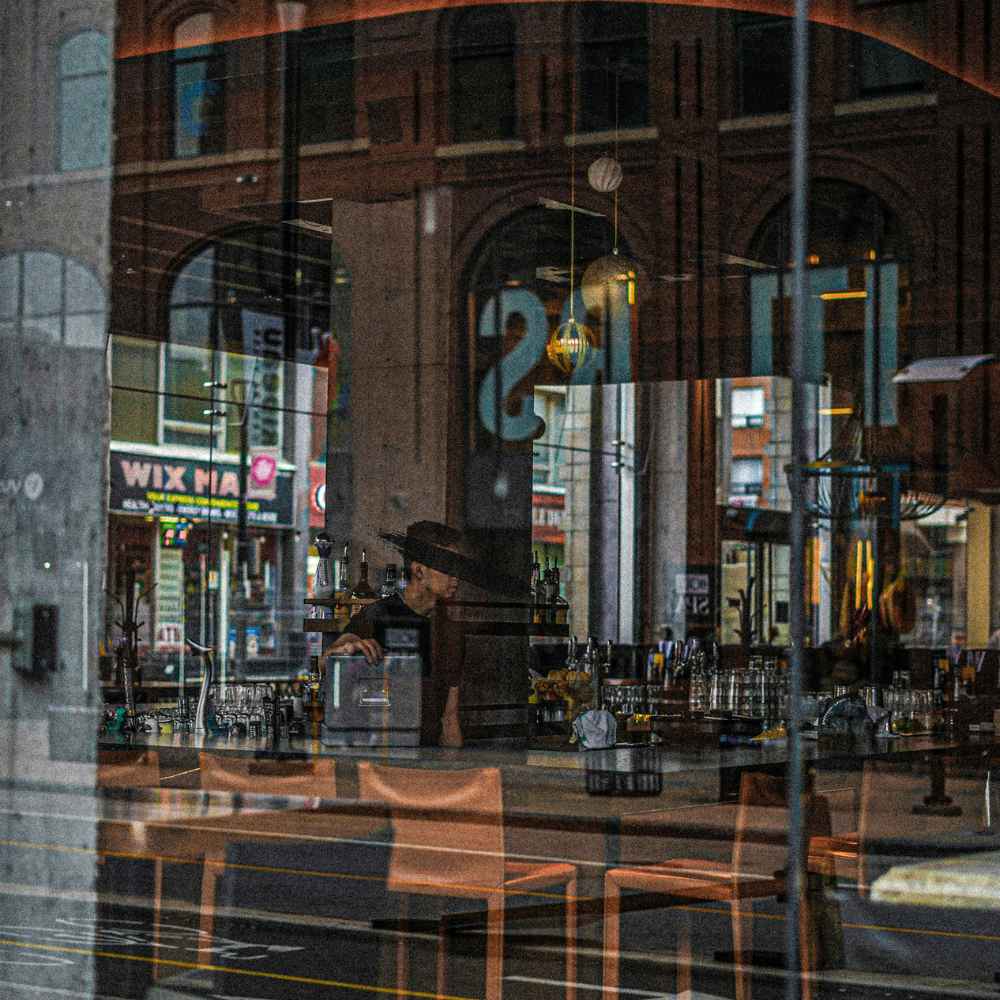 Reflection of a wine bar in ottawa with bartender