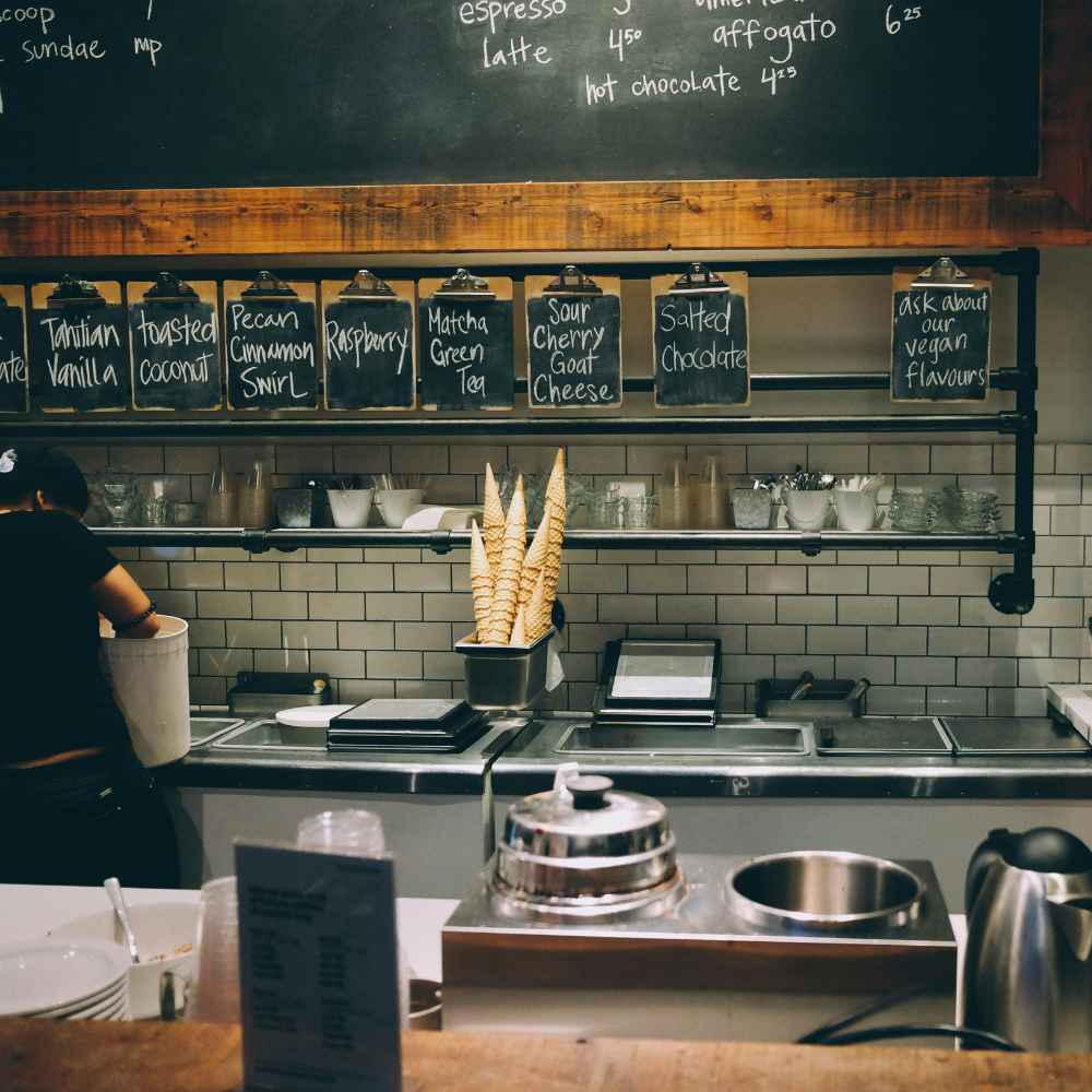 Ice cream shop food in vancouver showing different flavors and worker