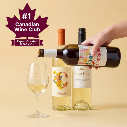 Wine pouring from a bottle labeled 'Afternoon' into a glass with other wine bottles on a beige background, featuring the #1 Canadian Wine Club logo.