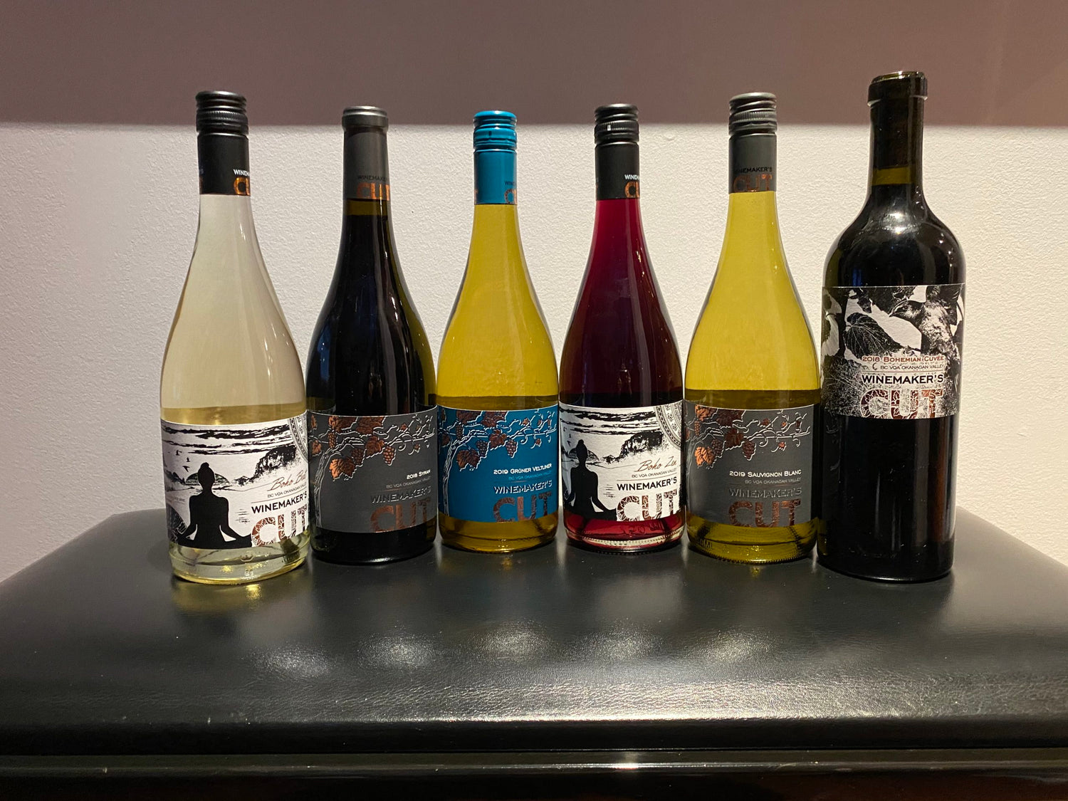 Winemaker's wine bottles displayed on a rustic table